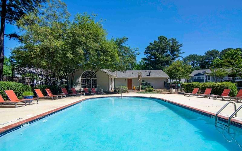 a swimming pool with chairs around it