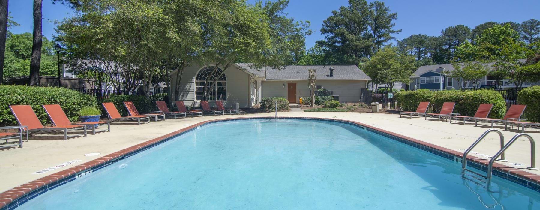 a swimming pool with chairs around it