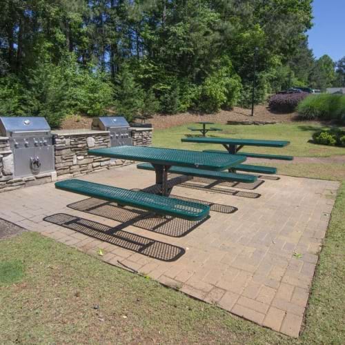 a backyard with a picnic table and chairs