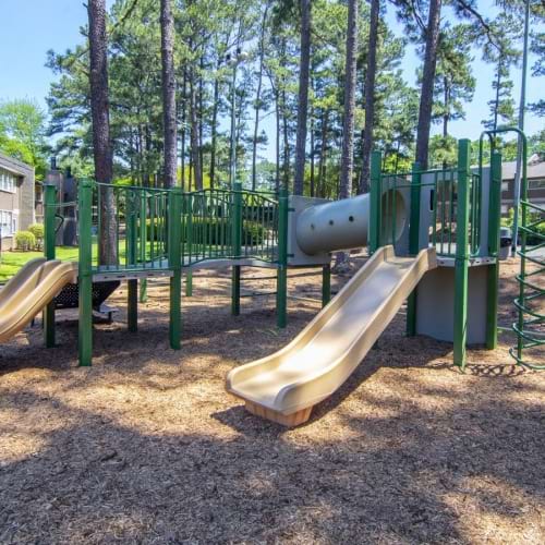 a playground with trees and buildings