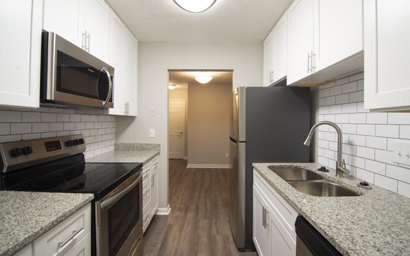 a kitchen with white cabinets