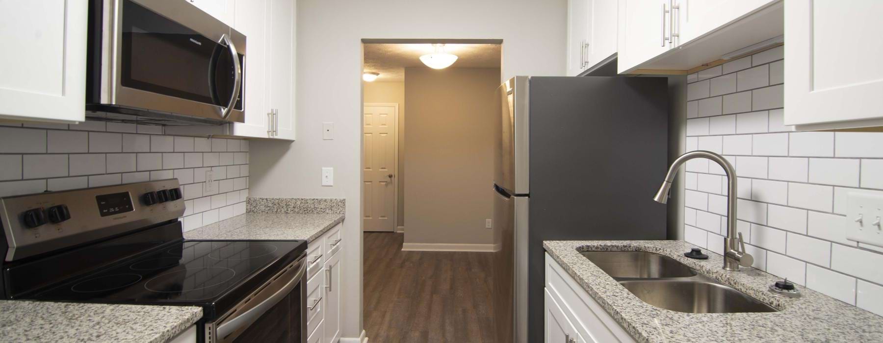 a kitchen with white cabinets
